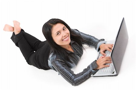 A young woman facing the camera with smile while both of her hand on the laptop. Foto de stock - Super Valor sin royalties y Suscripción, Código: 400-05091909