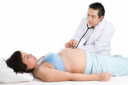 A young doctor is checking up the baby and mother health. Shot against white background. Stock Photo - Budget Royalty-Free & Subscription, Code: 400-05091952