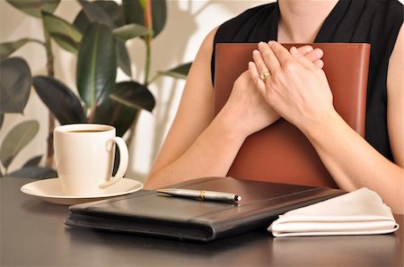 A woman in business attire conducts business in a restaurant or cafe. Focus on hands and torso with coffee and pen, paper, and binder elements. Stock Photo - Budget Royalty-Free & Subscription, Code: 400-05092241