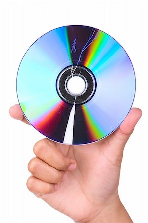 difración - A picture of a hand holding a broken CD or DVD with missing part on the below section, shoot against very bright white screen. Foto de stock - Super Valor sin royalties y Suscripción, Código: 400-05092365