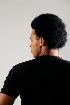Portrait of young african man posing from the back Stock Photo - Budget Royalty-Free & Subscription, Code: 400-05092694