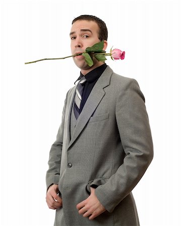 dragon_fang (artist) - A young man wearing a suit holding a single rose in his mouth, isolated against a white background Stock Photo - Budget Royalty-Free & Subscription, Code: 400-05092734