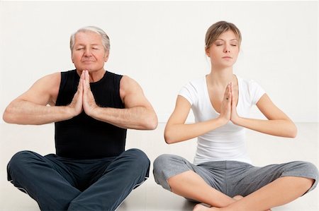 senior man and young woman doing yoga Stock Photo - Budget Royalty-Free & Subscription, Code: 400-05093221