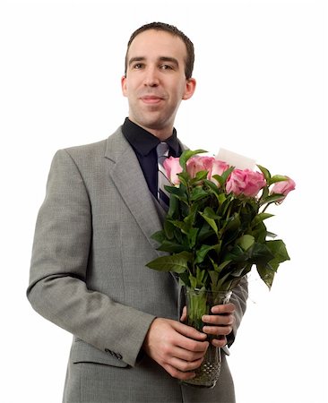 A young man holding a vase of roses, isolated against a white background Foto de stock - Super Valor sin royalties y Suscripción, Código: 400-05093314