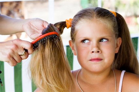 Little blond long hair girl has haircare by stylist. Stock Photo - Budget Royalty-Free & Subscription, Code: 400-05093423