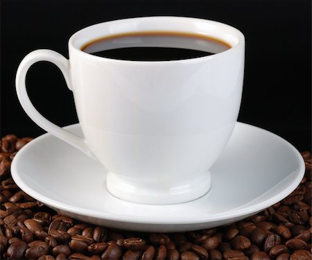 simsearch:400-04305840,k - Cup of coffee. A background with coffee grains and a white cup. A photo close up Foto de stock - Super Valor sin royalties y Suscripción, Código: 400-05104114