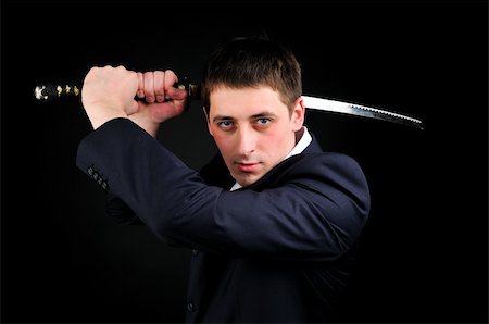 people in ready for fight - Young man hold sword Stock Photo - Budget Royalty-Free & Subscription, Code: 400-05105487