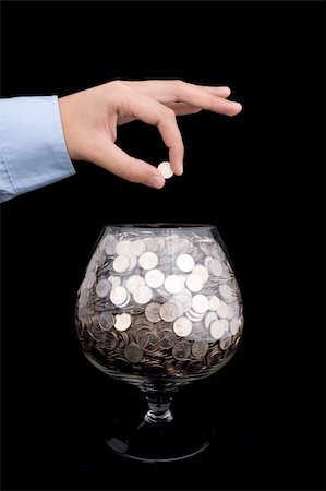 man's hand puts money into the glass Stock Photo - Budget Royalty-Free & Subscription, Code: 400-05106158