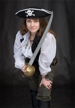 saber - The girl - pirate with a sabre in hands on a black background Stock Photo - Budget Royalty-Free & Subscription, Code: 400-05106363