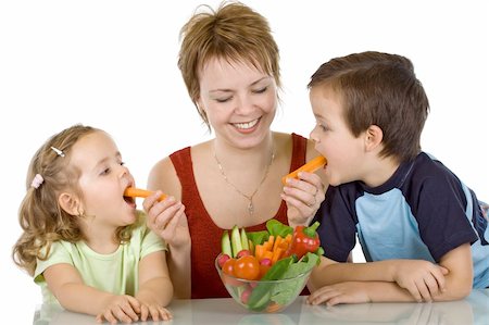 Woman feeding kids with vegetables - isolated Stock Photo - Budget Royalty-Free & Subscription, Code: 400-05106548