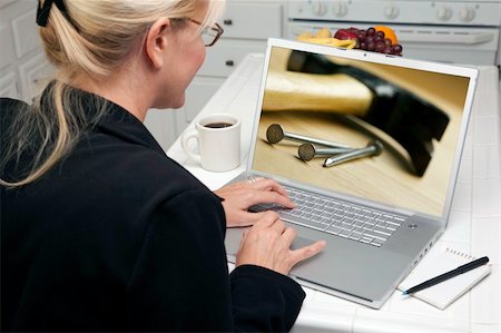 simsearch:400-06857713,k - Woman In Kitchen Using Laptop to Research Home Improvement. Screen can be easily used for your own message or picture. Picture on screen is my copyright as well. Fotografie stock - Microstock e Abbonamento, Codice: 400-05106604