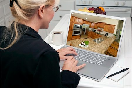 simsearch:400-05129327,k - Woman In Kitchen Using Laptop to Research Home Improvement Ideas. Screen can be easily used for your own message or picture. Picture on screen is my copyright as well. Stock Photo - Budget Royalty-Free & Subscription, Code: 400-05106605