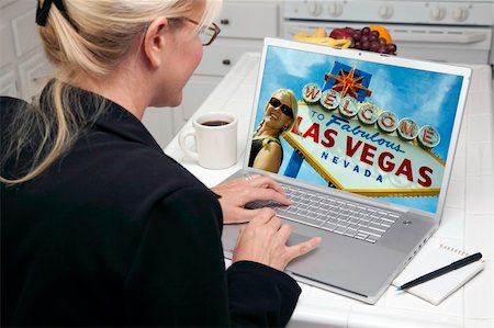 simsearch:400-05129327,k - Woman In Kitchen Using Laptop to Research A Las Vegas Trip. Screen can be easily used for your own message or picture. Picture on screen is my copyright as well. Stock Photo - Budget Royalty-Free & Subscription, Code: 400-05106606