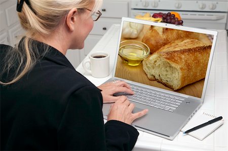 Woman In Kitchen Using Laptop to Research Cooking and Recipes. Screen can be easily used for your own message or picture. Picture on screen is my copyright as well. Stock Photo - Budget Royalty-Free & Subscription, Code: 400-05106600