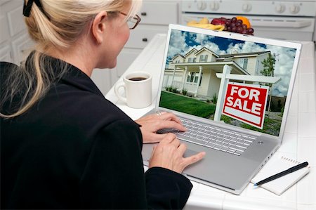 simsearch:400-05129327,k - Woman In Kitchen Using Laptop to Research Real Estate. Screen can be easily used for your own message or picture. Picture on screen is my copyright as well. Stock Photo - Budget Royalty-Free & Subscription, Code: 400-05106617