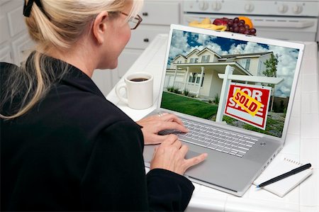 Woman In Kitchen Using Laptop to Research Real Estate. Screen can be easily used for your own message or picture. Picture on screen is my copyright as well. Stock Photo - Budget Royalty-Free & Subscription, Code: 400-05106618