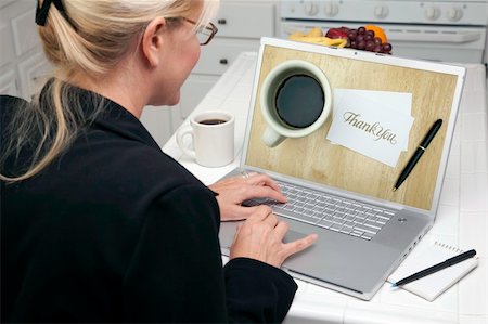 Woman In Kitchen Using Laptop with Thank You Image on Screen. Screen can be easily used for your own message or picture. Picture on screen is my copyright as well. Stock Photo - Budget Royalty-Free & Subscription, Code: 400-05106624