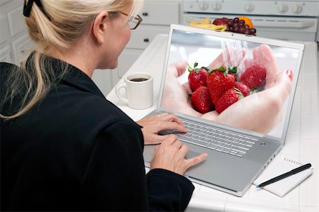 Woman In Kitchen Using Laptop to Research Cooking and Recipes. Screen can be easily used for your own message or picture. Picture on screen is my copyright as well. Stock Photo - Budget Royalty-Free & Subscription, Code: 400-05106623