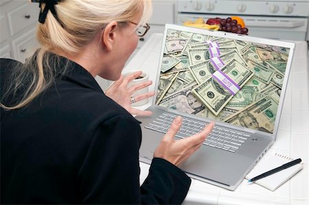 Excited Woman In Kitchen Using Laptop to Earn or Win Money. Screen can be easily used for your own message or picture. Picture on screen is my copyright as well. Stock Photo - Budget Royalty-Free & Subscription, Code: 400-05106630