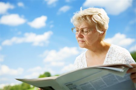 simsearch:693-06019332,k - The elderly lady with the newspaper against the sky Stock Photo - Budget Royalty-Free & Subscription, Code: 400-05106736
