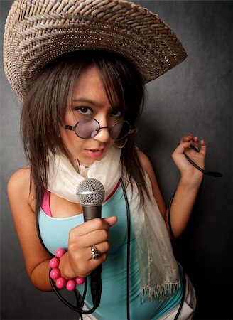 Pretty young singer with a large microphone Stock Photo - Budget Royalty-Free & Subscription, Code: 400-05108124