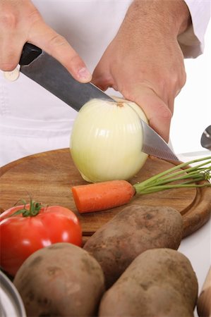 simsearch:400-04114281,k - chef preparing lunch and cutting onion with knife Photographie de stock - Aubaine LD & Abonnement, Code: 400-05108409