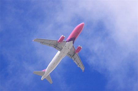 plane flying large sky blue wing - Jet airplane on almost clear blue sky witch some clouds Stock Photo - Budget Royalty-Free & Subscription, Code: 400-05108527