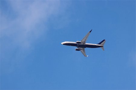 plane flying large sky blue wing - Jet airplane on almost clear blue sky witch some clouds Stock Photo - Budget Royalty-Free & Subscription, Code: 400-05108523