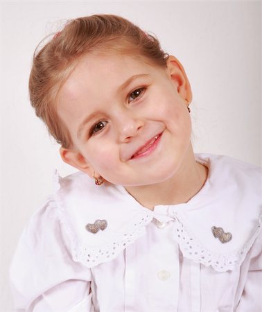 simsearch:400-04161658,k - Beautiful small girl is smiling  sincerely Fotografie stock - Microstock e Abbonamento, Codice: 400-05108733