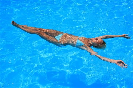 Pretty blonde woman enjoying a swimming pool in Greece Stock Photo - Budget Royalty-Free & Subscription, Code: 400-05109035