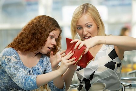 empty wallet - Two girls shake out purse contents in cafe Stock Photo - Budget Royalty-Free & Subscription, Code: 400-05100659