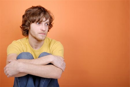 reverie - Sad young man on an orange background Stock Photo - Budget Royalty-Free & Subscription, Code: 400-05101183