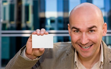 dpix (artist) - smiling successful man showing his business card Photographie de stock - Aubaine LD & Abonnement, Code: 400-05101204