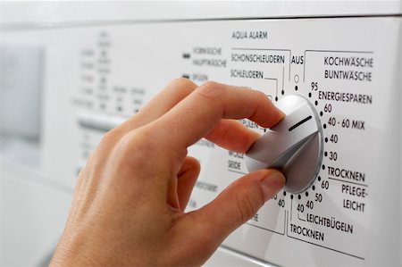 dpix (artist) - a hand is adjusting the washing program on a washing machine (German Text) Photographie de stock - Aubaine LD & Abonnement, Code: 400-05101206