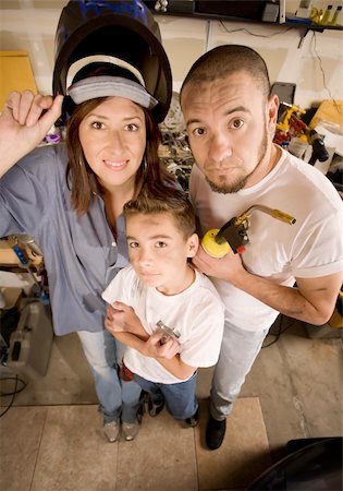 Funny Hispanic family in garage with variety of tools Stock Photo - Budget Royalty-Free & Subscription, Code: 400-05101567