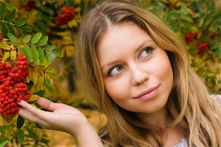 Pretty young woman touching ashberries in an autumn park Stock Photo - Budget Royalty-Free & Subscription, Code: 400-05102349