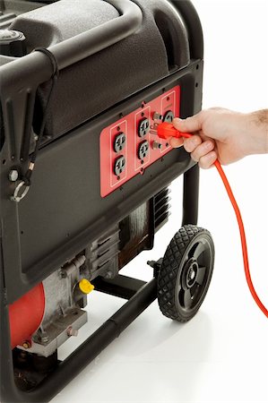 emergency supplies - Someone plugging an extension cord into a portable gasoline generator. Stock Photo - Budget Royalty-Free & Subscription, Code: 400-05102556