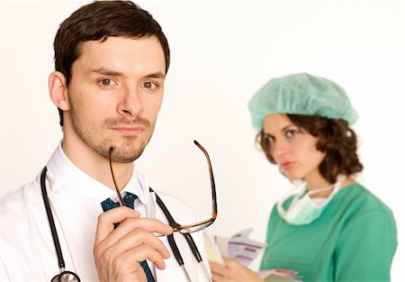 medical doctor with glasses and stethoscope, nurse in background Stock Photo - Budget Royalty-Free & Subscription, Code: 400-05103220