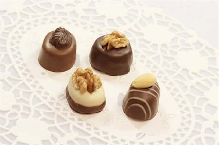 Four tasty chocolates with nuts Photographie de stock - Aubaine LD & Abonnement, Code: 400-05114576