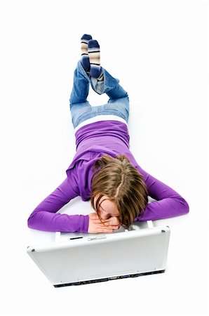 Tired young girl lying down asleep on laptop computer Stock Photo - Budget Royalty-Free & Subscription, Code: 400-05114746