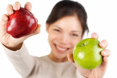 simsearch:400-04564926,k - Beautiful smiling young woman presenting 2 apples, red and green. Isolated on white. Photographie de stock - Aubaine LD & Abonnement, Code: 400-05114793