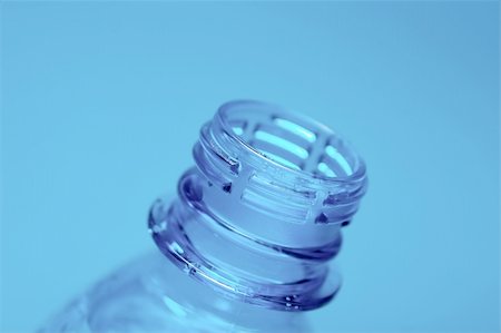 Neck of an open plastic water bottle on blue background Stock Photo - Budget Royalty-Free & Subscription, Code: 400-05115015