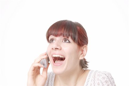 Closeup portrait of a happy young woman yealing on the phone isolated on white background Stockbilder - Microstock & Abonnement, Bildnummer: 400-05115098