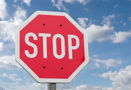 Stop sign against blue sky and clouds Stock Photo - Budget Royalty-Free & Subscription, Code: 400-05116225