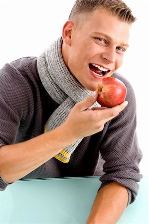 smiling young man posing with apple with white background Stock Photo - Budget Royalty-Free & Subscription, Code: 400-05116548