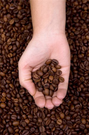 simsearch:400-06701416,k - woman holding coffee beans in the hand. Portrait orientation. Stock Photo - Budget Royalty-Free & Subscription, Code: 400-05117073