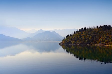 simsearch:400-05117107,k - Mountain peaks covered with blue mist, still waterscape and autumn woods on the background in Montenegro. Stock Photo - Budget Royalty-Free & Subscription, Code: 400-05117095