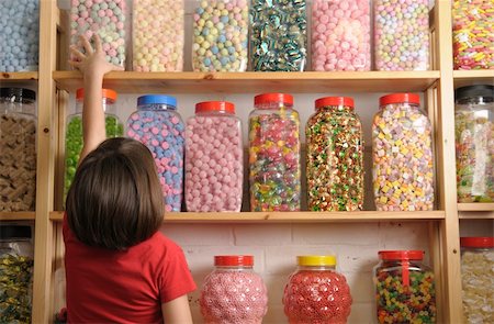 spoiled for choice - child reaching for sweet jar on top shelf Stock Photo - Budget Royalty-Free & Subscription, Code: 400-05117205