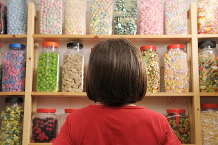 spoiled for choice - young girl looking at rows of sweets in shop Stock Photo - Budget Royalty-Free & Subscription, Code: 400-05117207