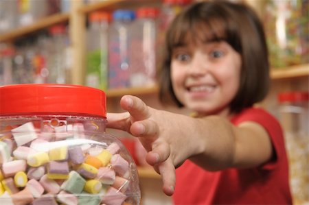 spoiled for choice - young girl grabbing a jar of sweets in shop Stock Photo - Budget Royalty-Free & Subscription, Code: 400-05117208